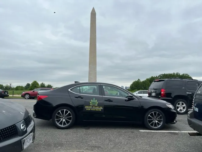 Black Heady Club DC vehicle featuring the business logo, set against the backdrop of a Washington DC monument