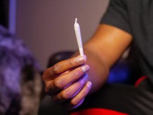 A person holding up a joint 