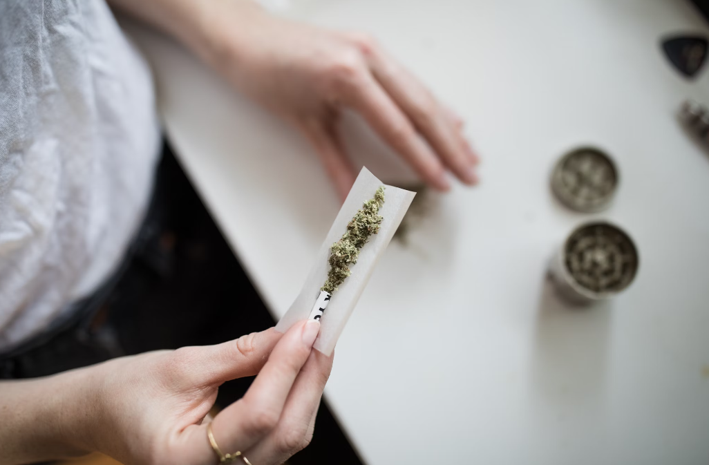 A person rolling a joint.