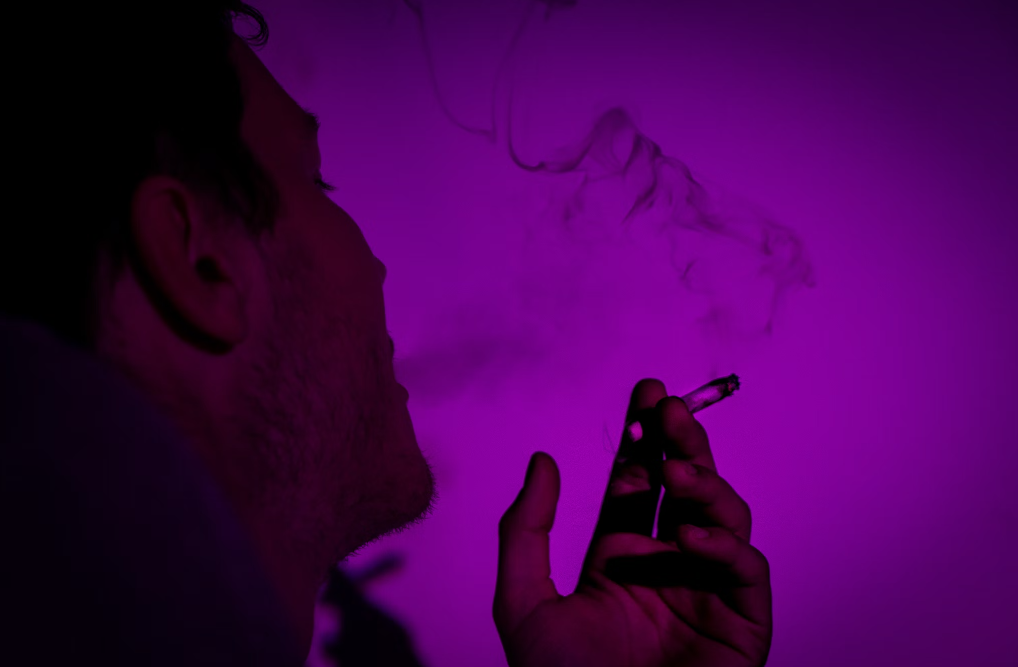 A man smoking a joint.