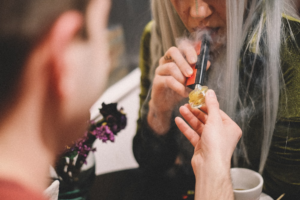 A woman smoking cannabis from a weed store