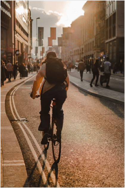 An image of a man cycling on the street