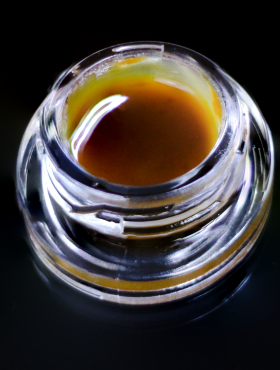 Detailed close-up of Kush Mints concentrate, revealing its amber hues and concentrated cannabis essence in a captivating macro perspective.